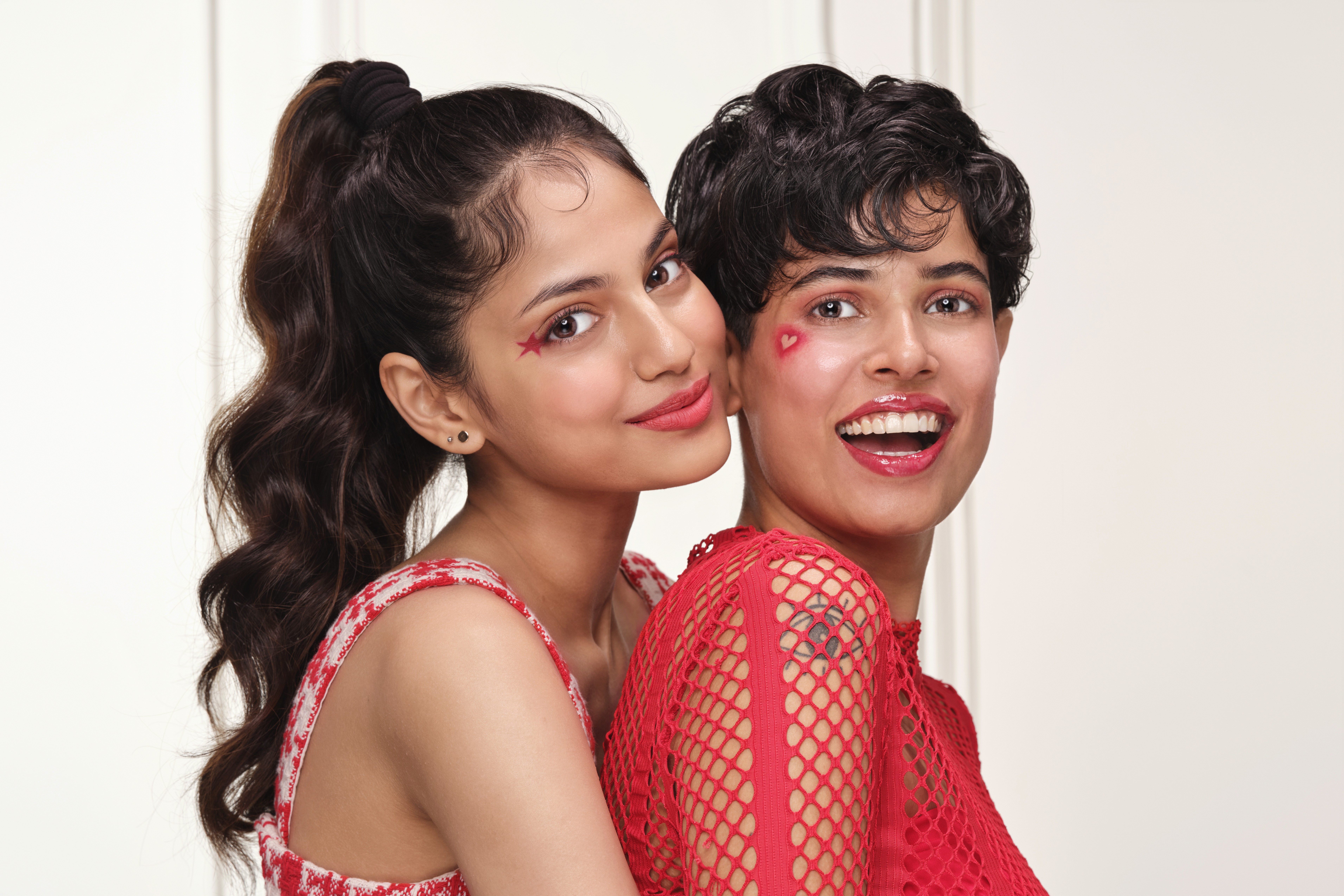 Group of friends smiling on a lively city street at night