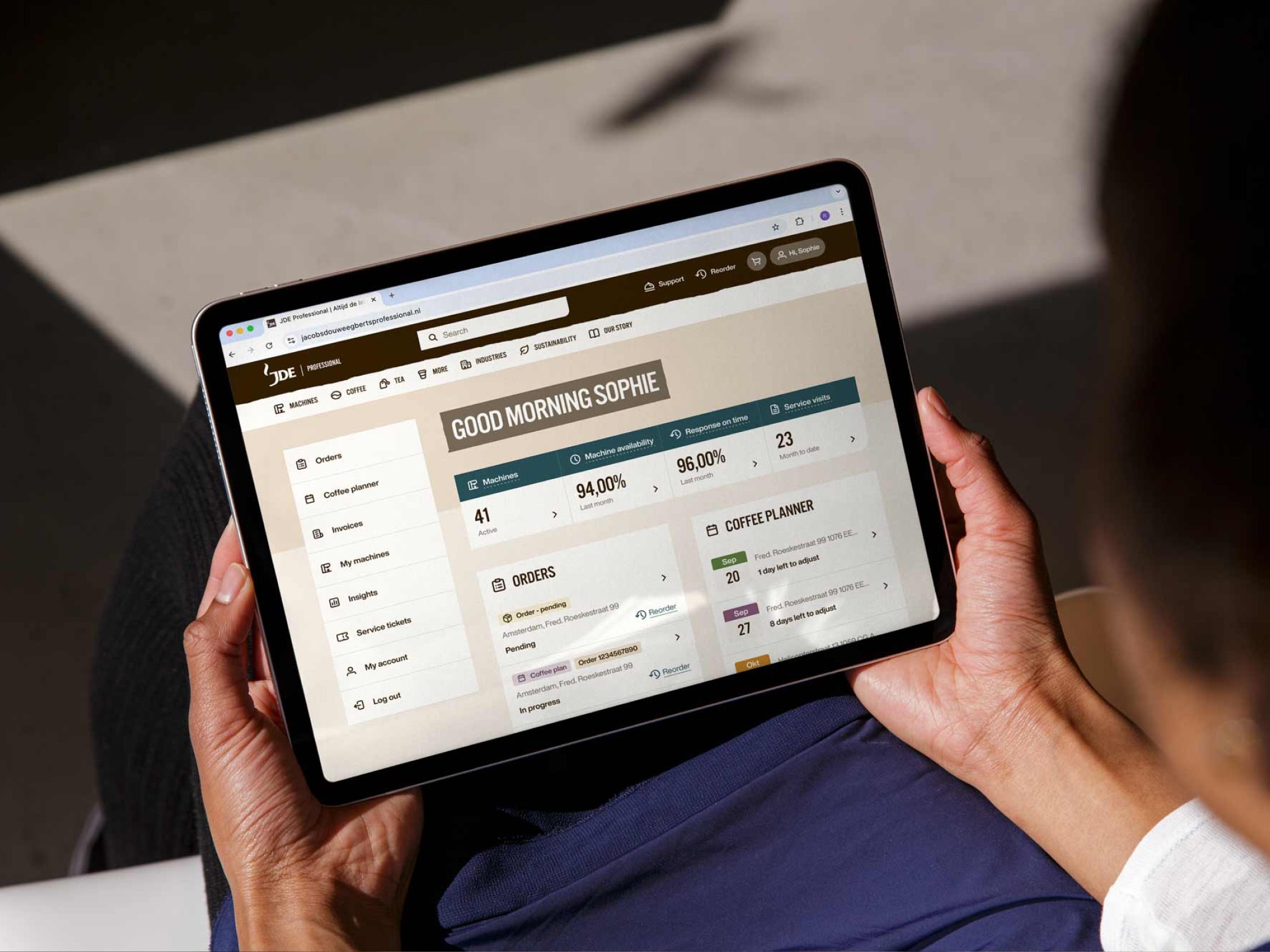 JDE Peet's — image of a user holding a tablet with the service environment visible — Soda Studio case study