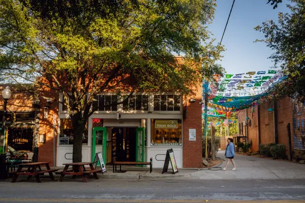A vibrant brick storefront and outdoor seating area in the Bishop Arts District, serving as a landmark near modern couples therapy and intimacy counseling services in Dallas.