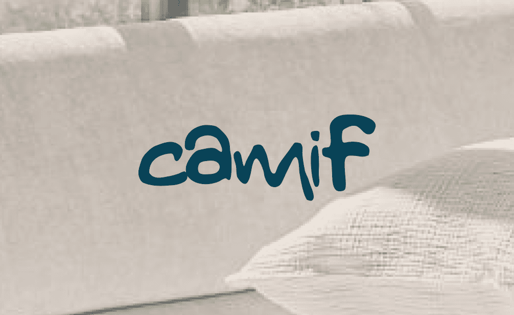 Camif logo on a light-colored, textured fabric, possibly a sofa or mattress.