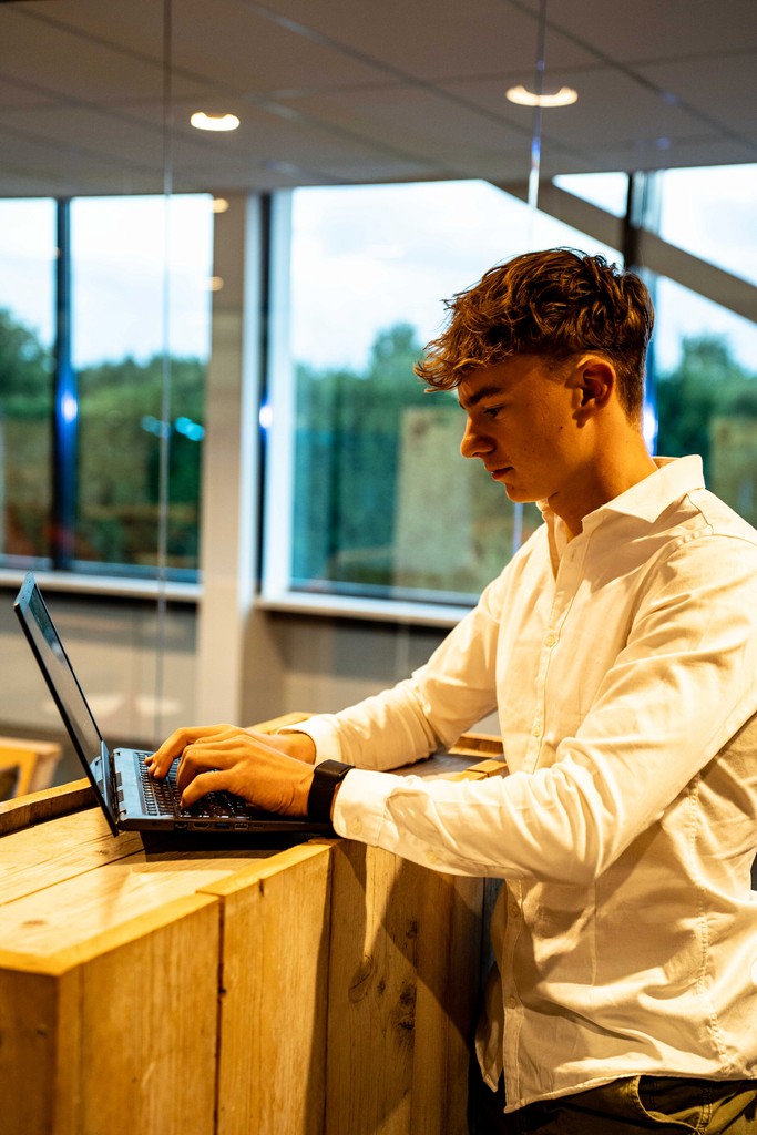 A hand holding a black pen, poised to write or draw on a surface.
