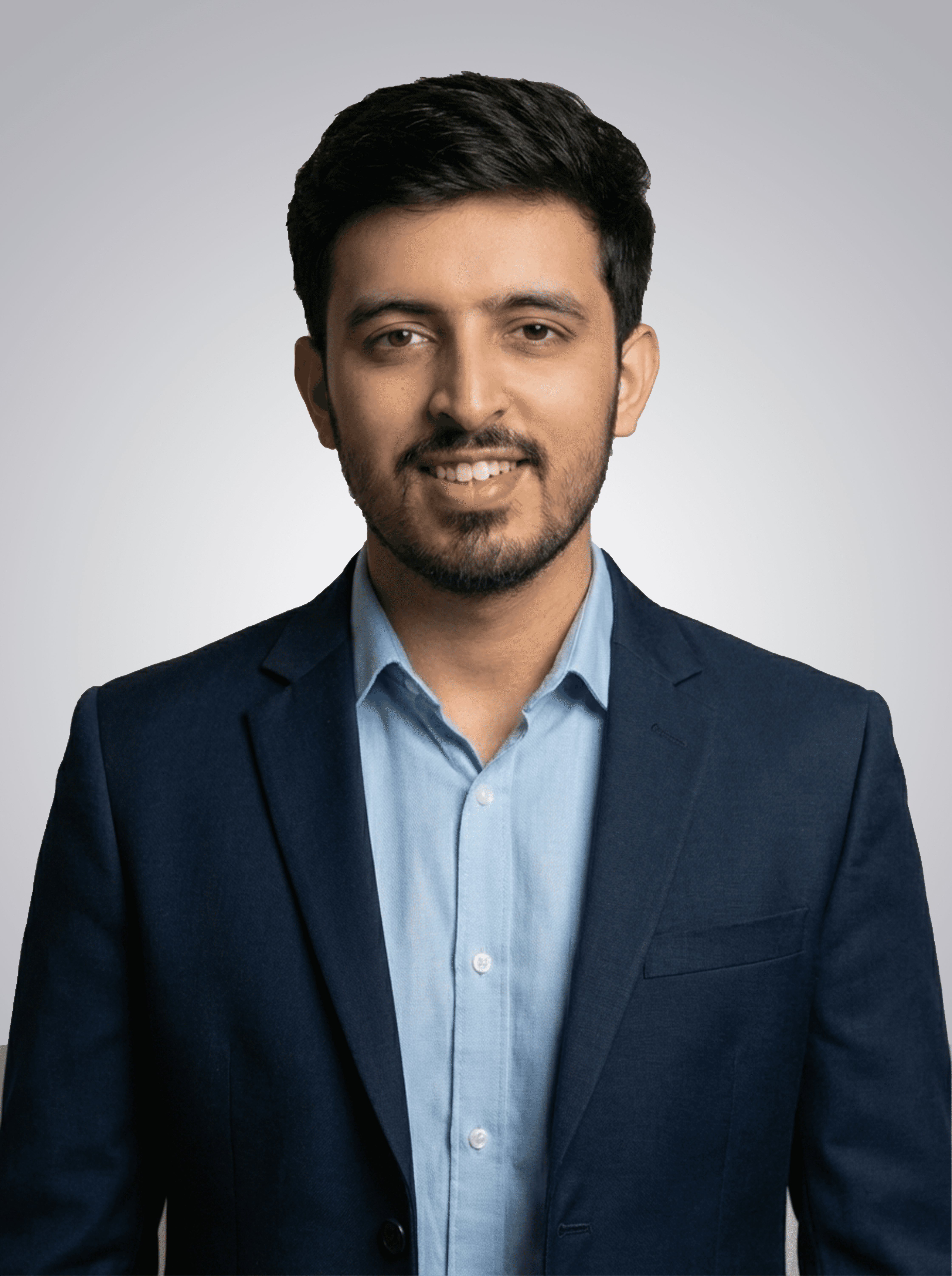 A man with glasses and a brown shirt, crossing his arms.