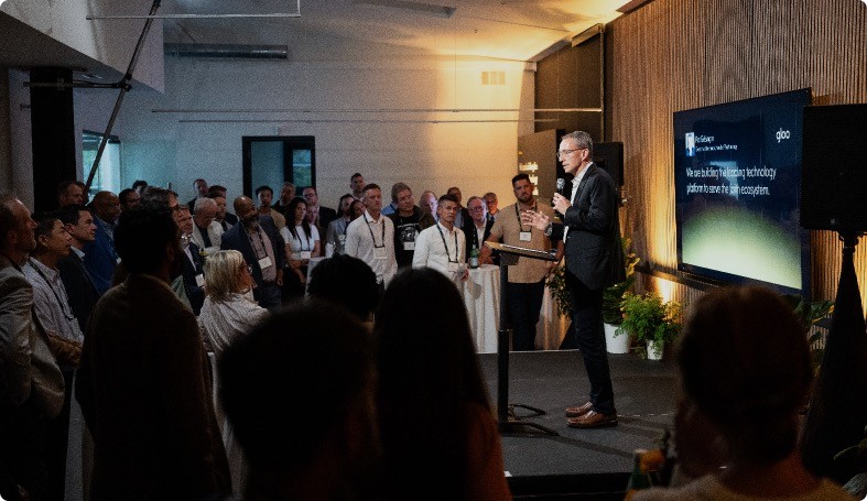 Person at podium with a bible and a phone.