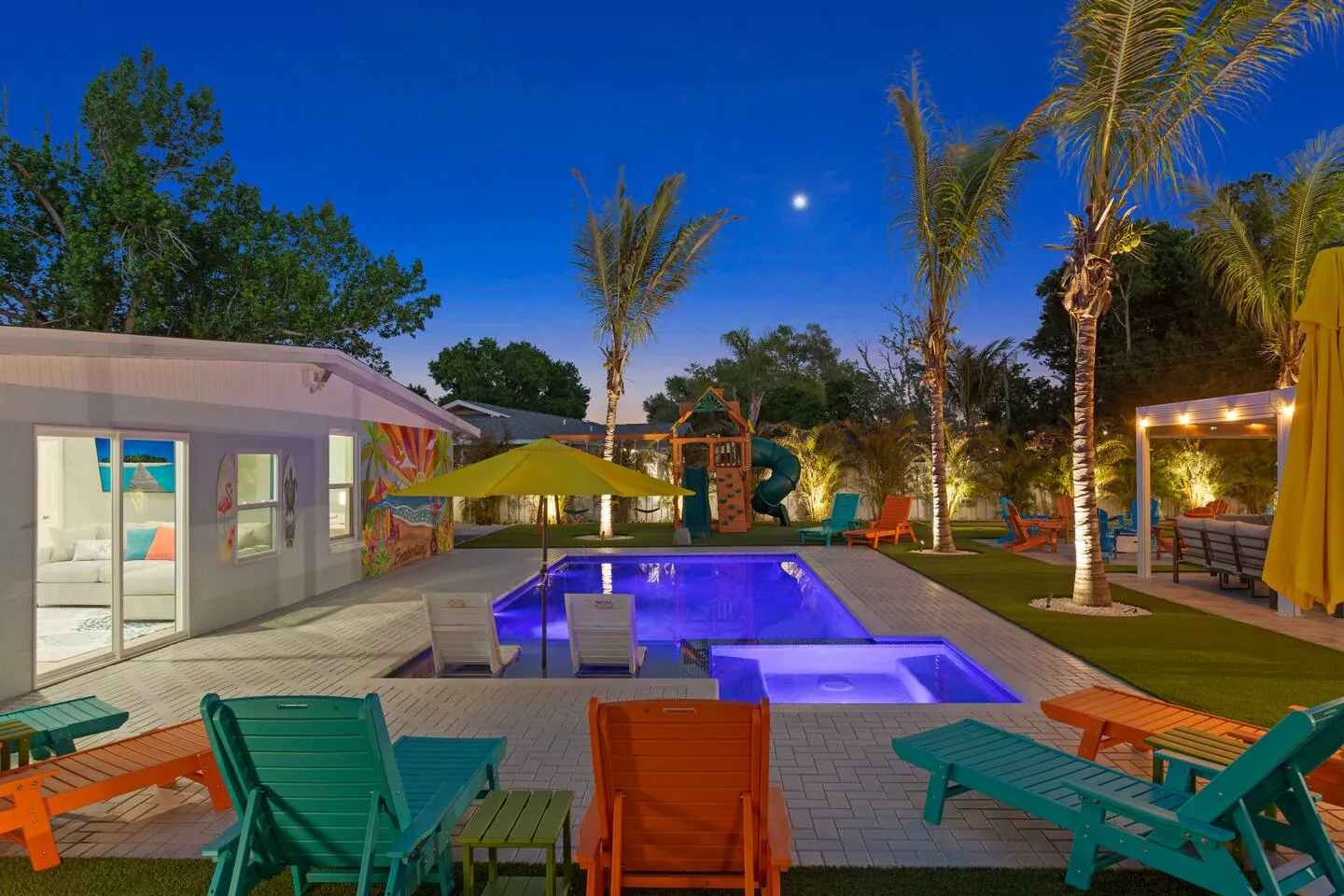 Pool lit at twilight at Private Backyard Resort, Bradenton, Florida