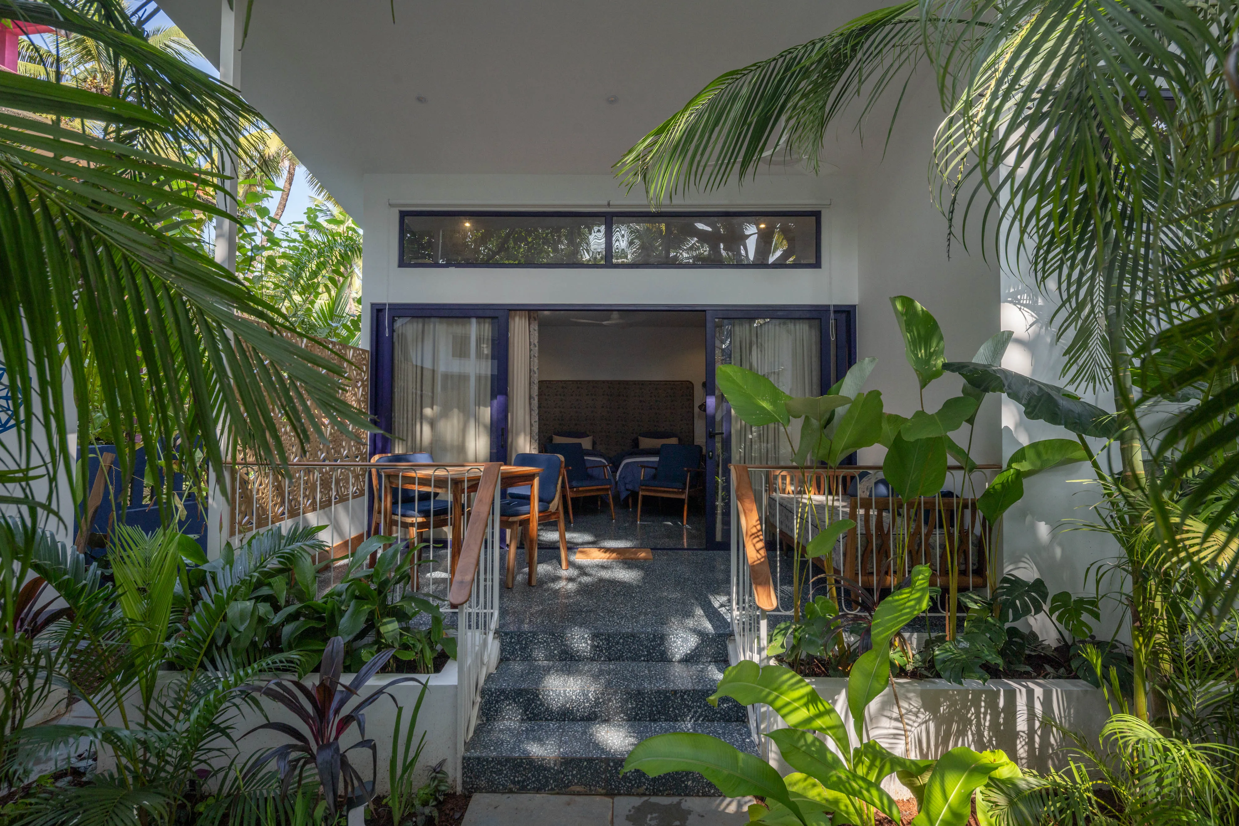 A room glimpsed through the greenery at Jaali Blue