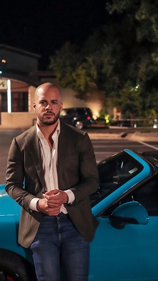 Alexander leaning on his sports car