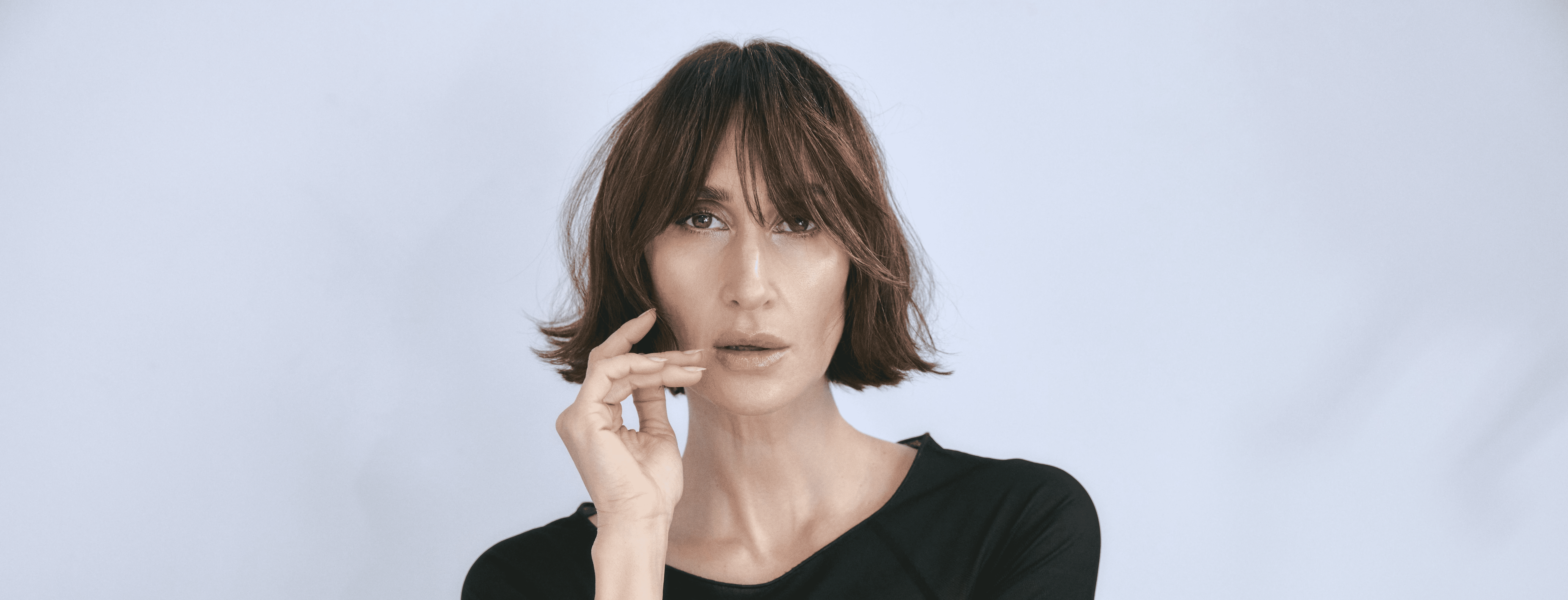 Laptop displaying website on wooden table