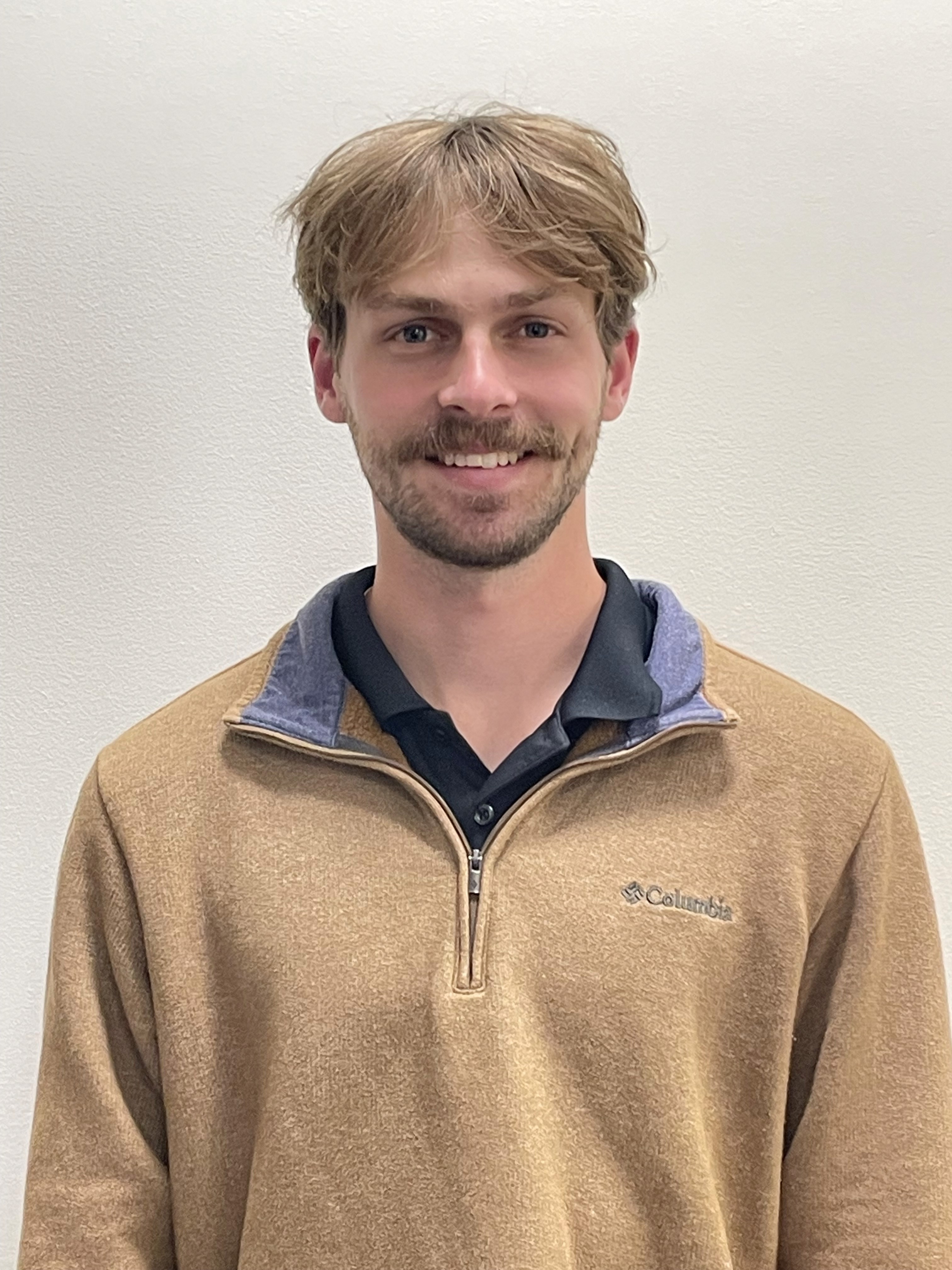 woman holding a phone and man looking at the phone. both are smiling