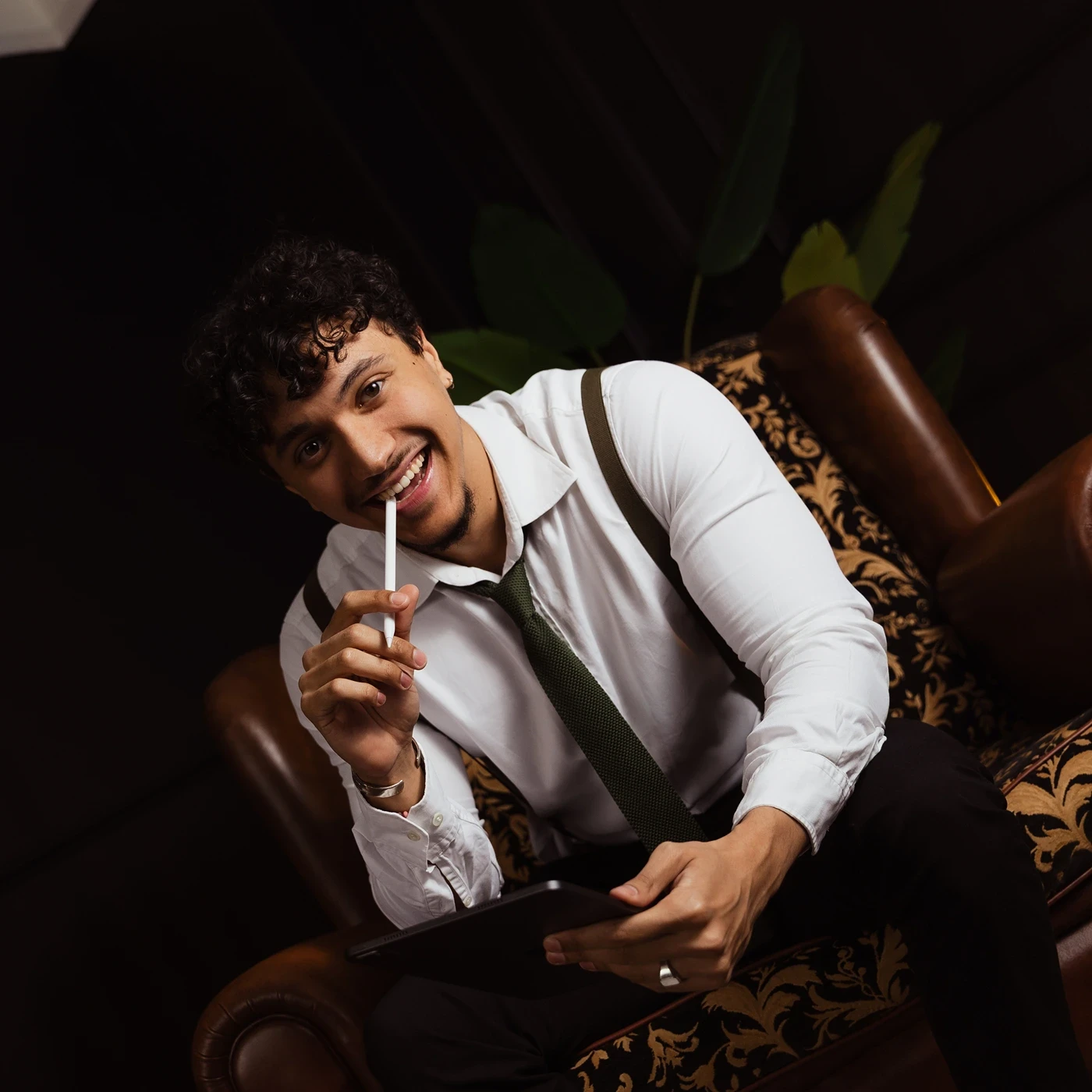 A red hot air balloon glows at sunset over mountains.