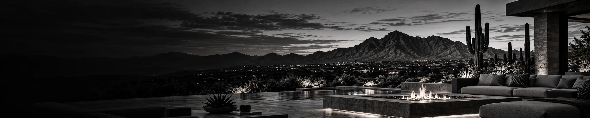 Modern Arizona terrace at night with a fire table and mountain views