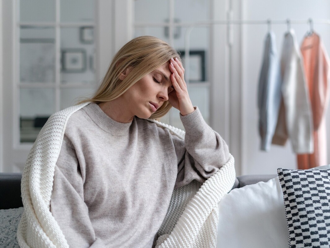 woman feeling fatigued after overdoing riding a stationary bike for weight loss too often