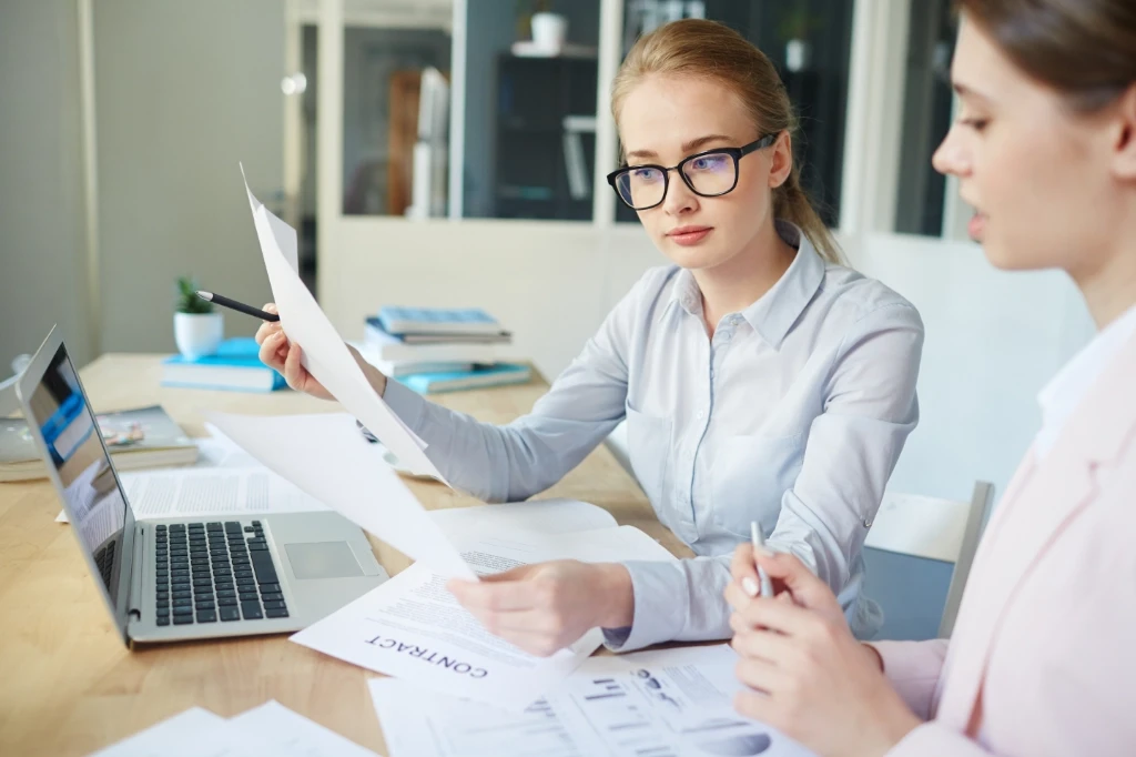 Two females reviewing documents.