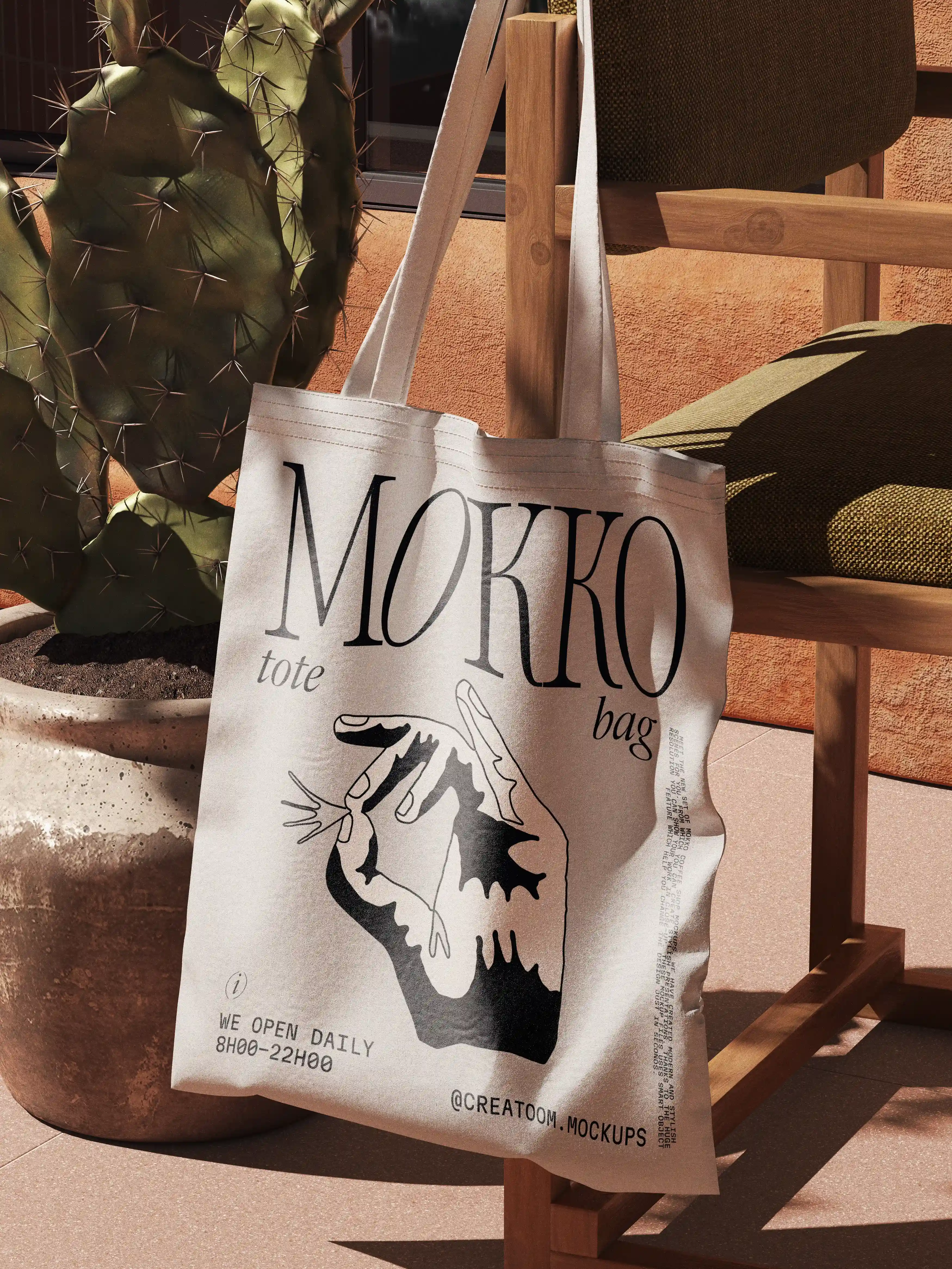 Mokko branded canvas tote bag hanging on chair beside cactus