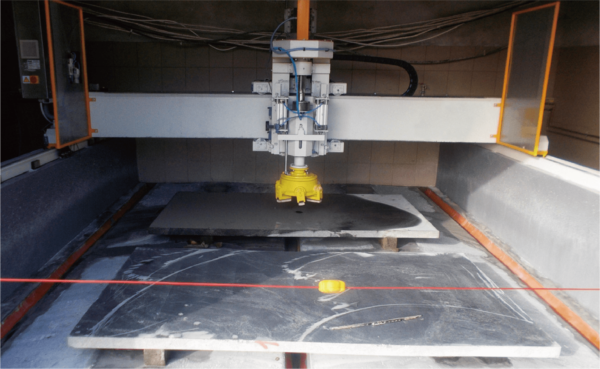 The Bridge Single Head Automatic Polisher operating in a production setting, highlighting its robust design and efficient performance in processing various stone materials.