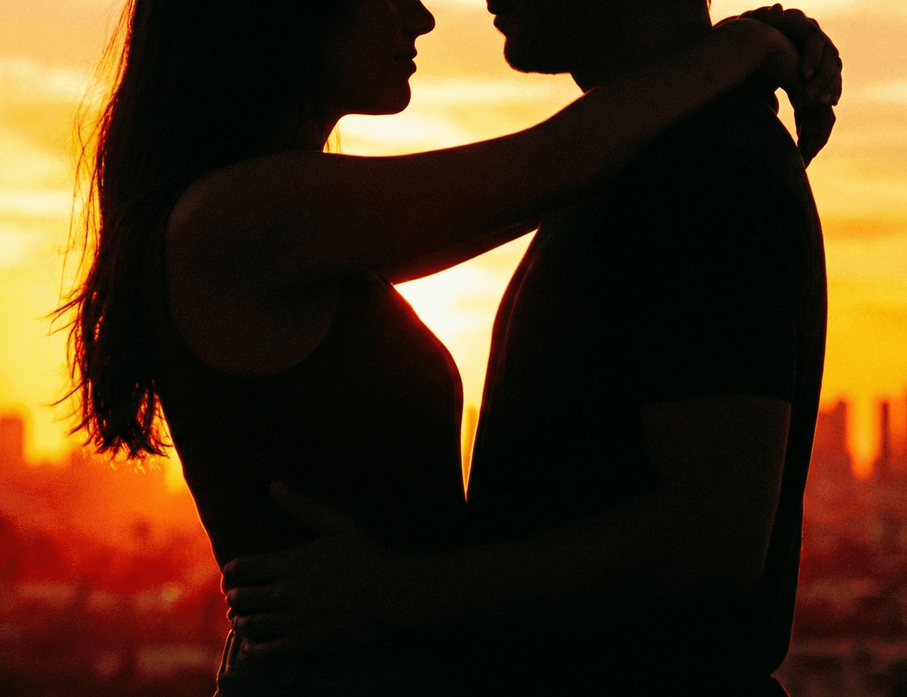 smiling woman sitting on grass during daytime