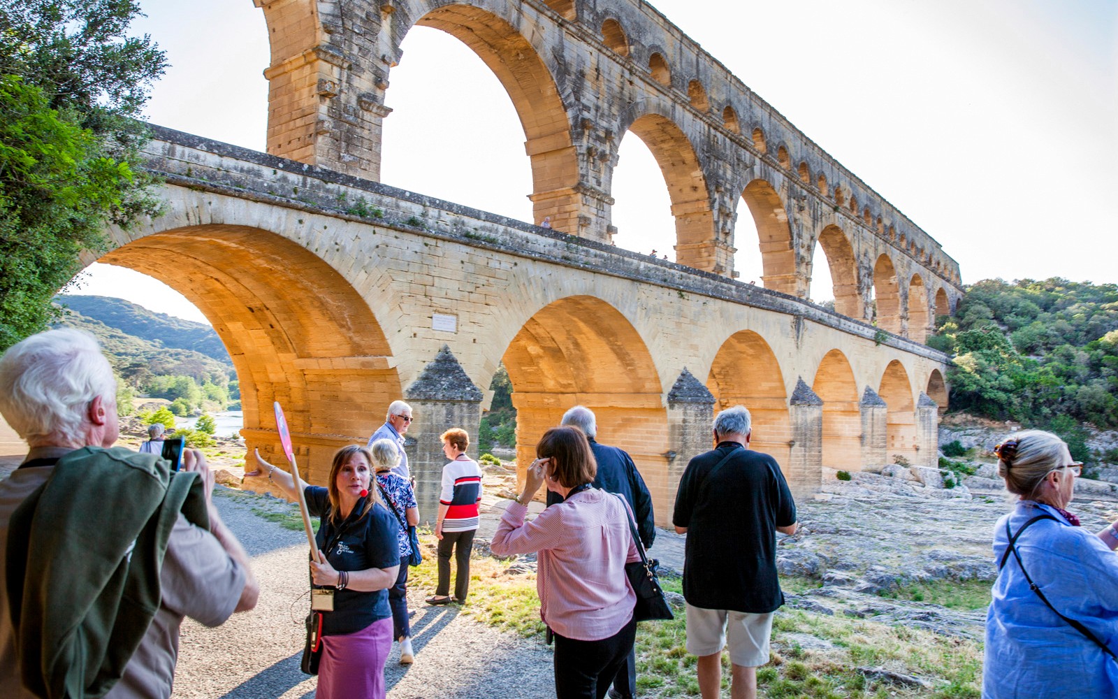 Tour group exploring Pont du Gard aqueduct on Provence Full Day Tour from Aix-en-Provence.