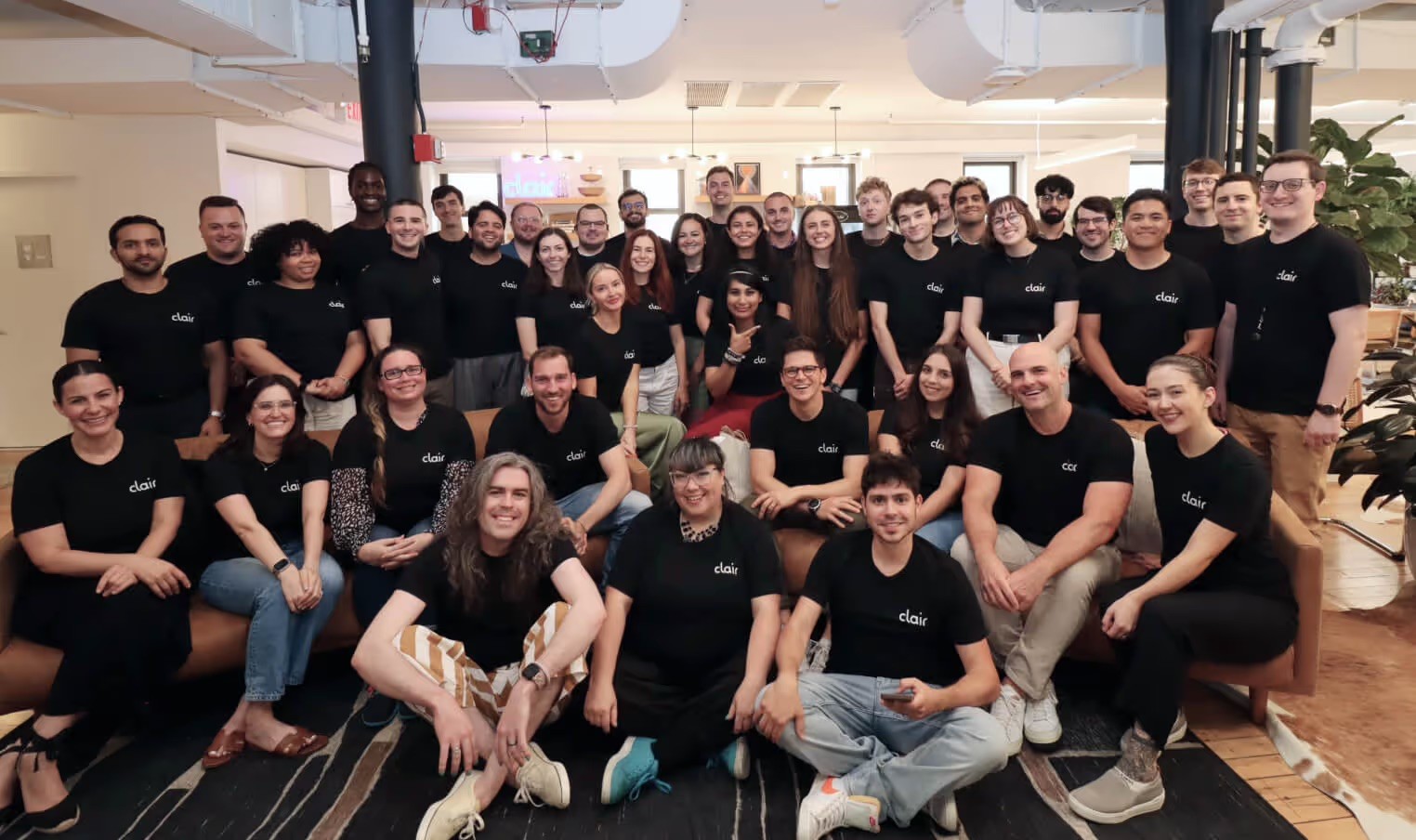 The Clair team wearing branded t-shirts, gathered for a group photo