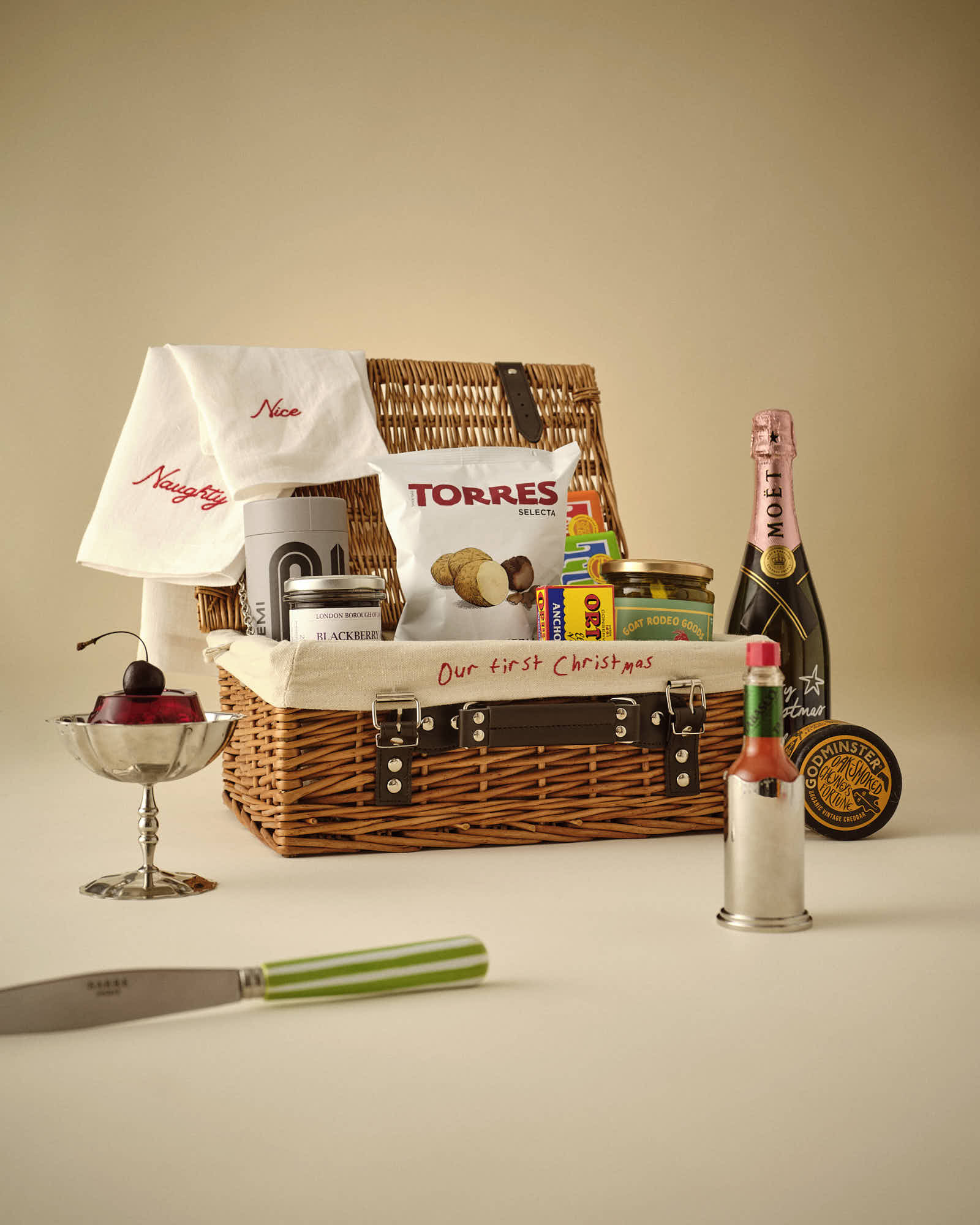 A detailed scene featuring a whimsical display with various items atop a vintage hamper box against a plain background.