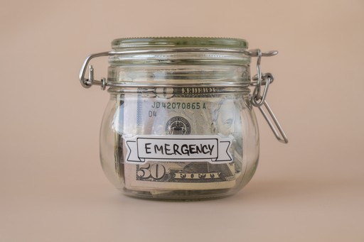 mason jar filled with money and a tag stating emergency fund