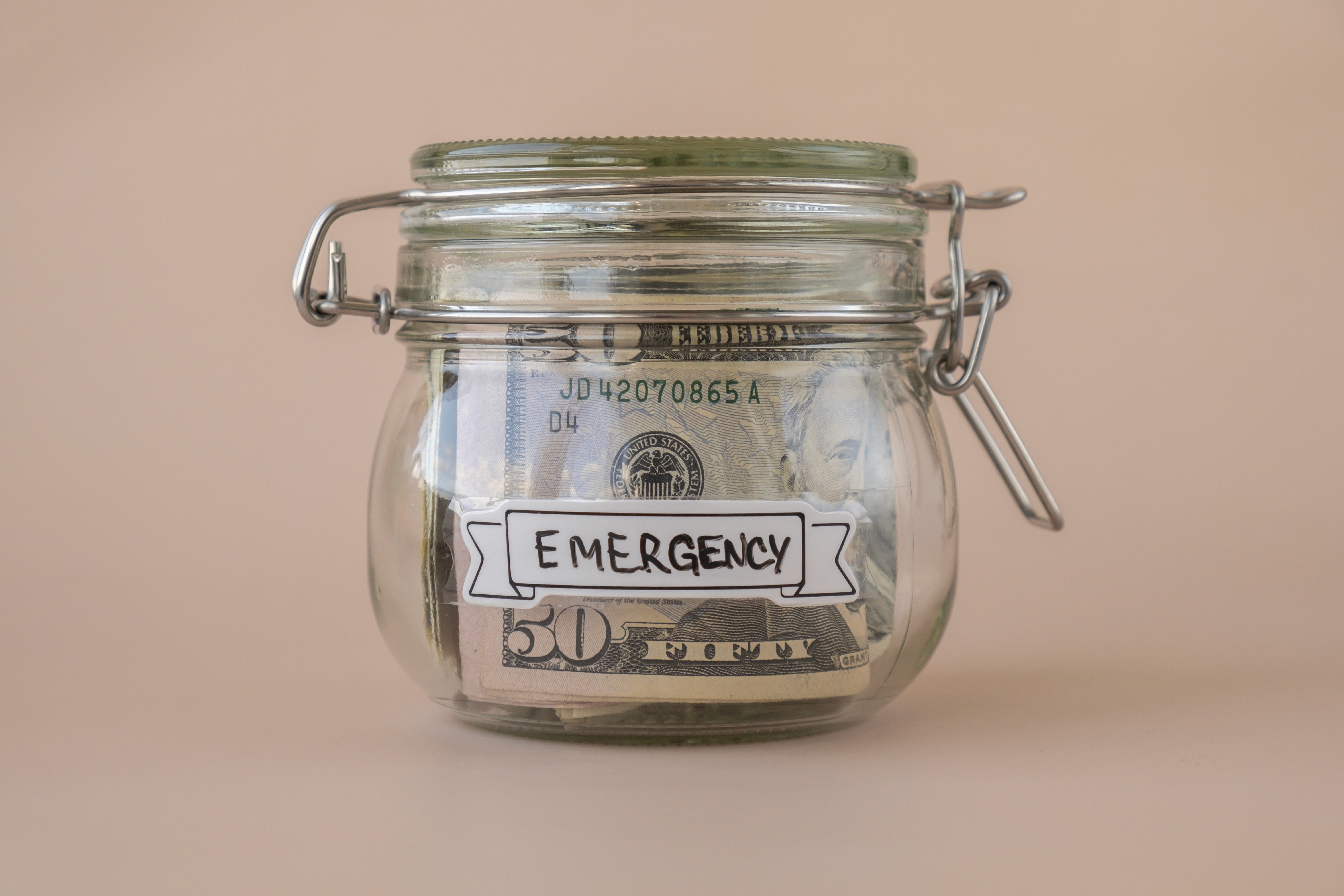 saving-money-in-glass-jar-filled-with-dollars-bank