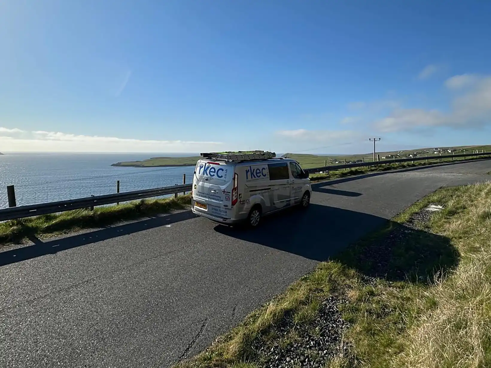 Electrical engineer van driving on UK coast, facilitating domestic and commercial repairs and maintenance services nationwide.