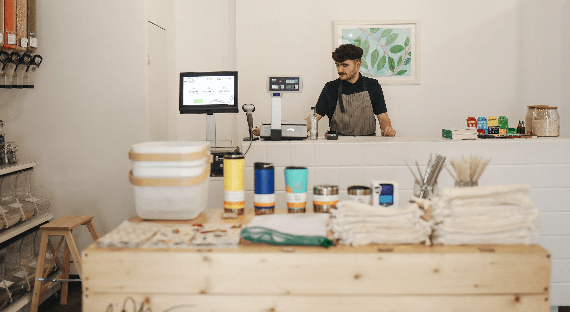 Small business owner behind a counter in a retail shop in Portugal