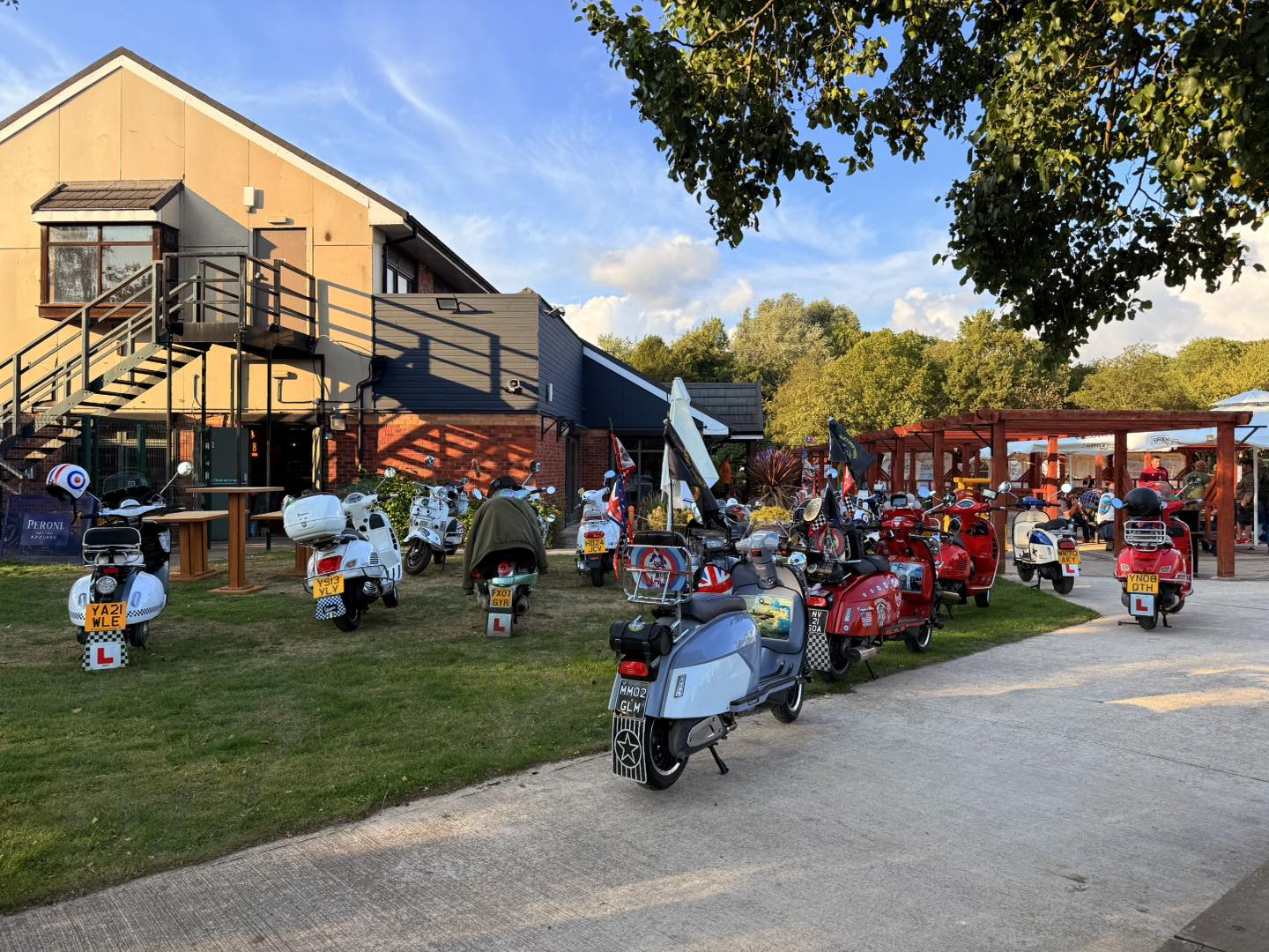 A group of scooters parked up outside 1988 bar