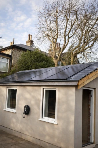 Solar panel installation on a newly re-roofed annex in Essex, featuring in-roof mounting, hybrid inverter, battery storage and EV charger for self-sufficient renewable energy generation.
