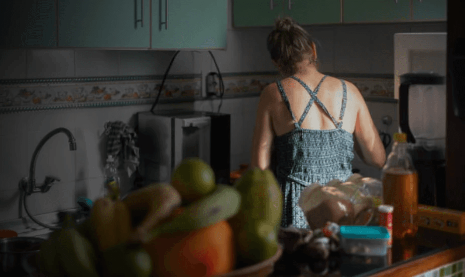A photo of a caregiver in kitchen that represents finding innovative ways to better care for caregivers.