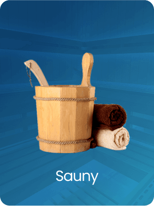 A smiling woman with her arms crossed, standing against a dark green background. She has long, dark hair.