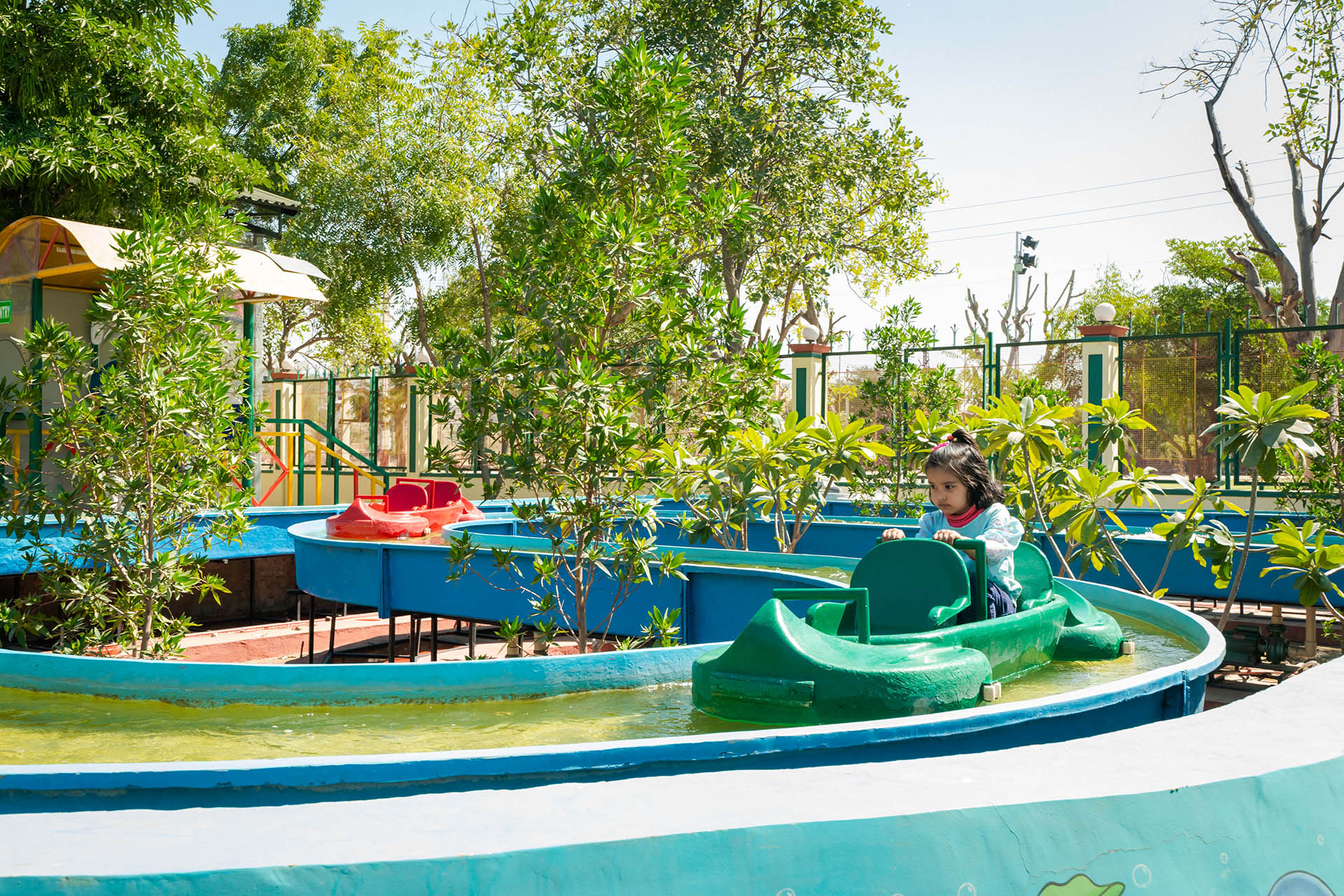 Sunlit orange chair on wooden floor near staircase.