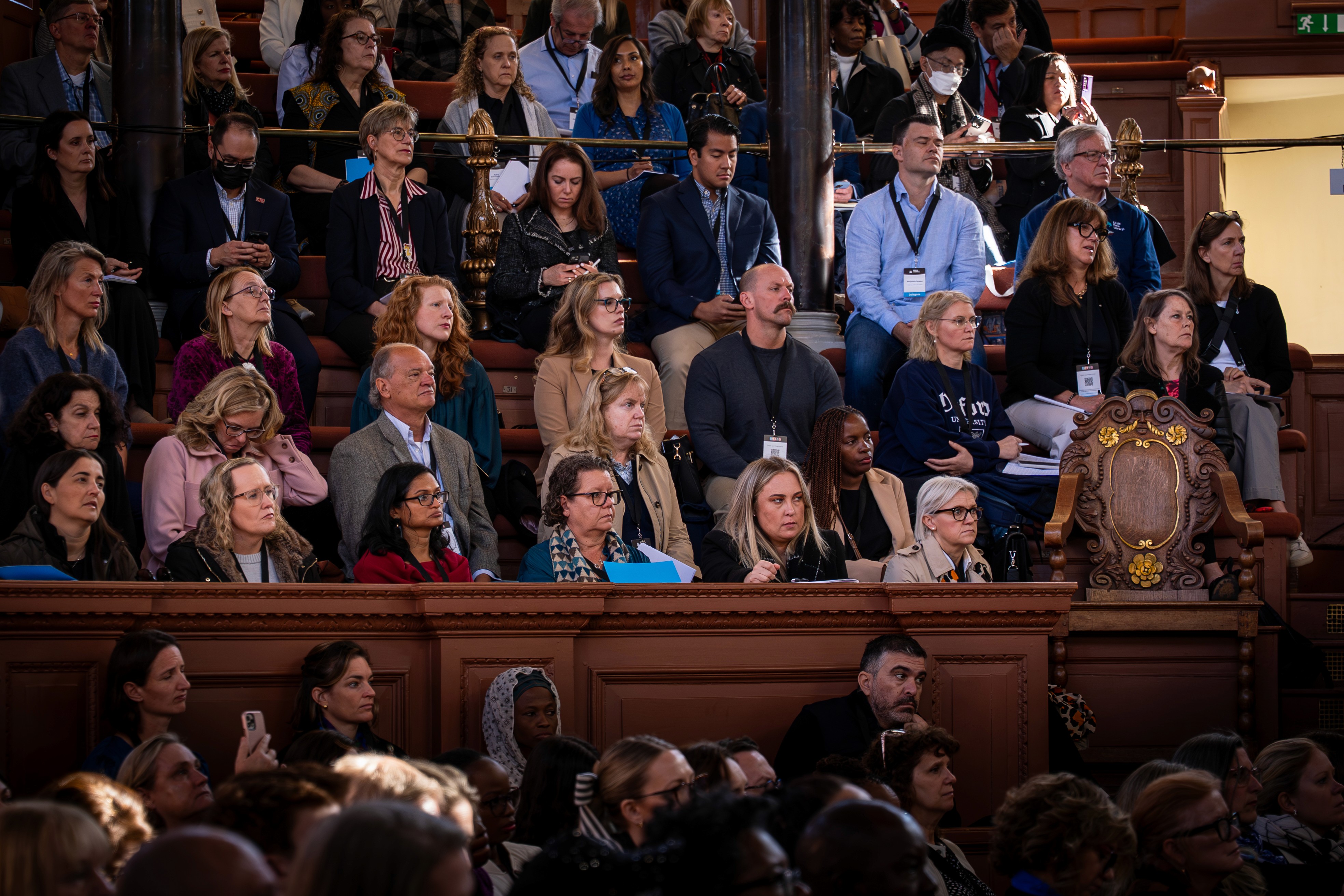 A speaker presenting at an AI conference in front of an audience, discussing real-world approaches to building AI products.