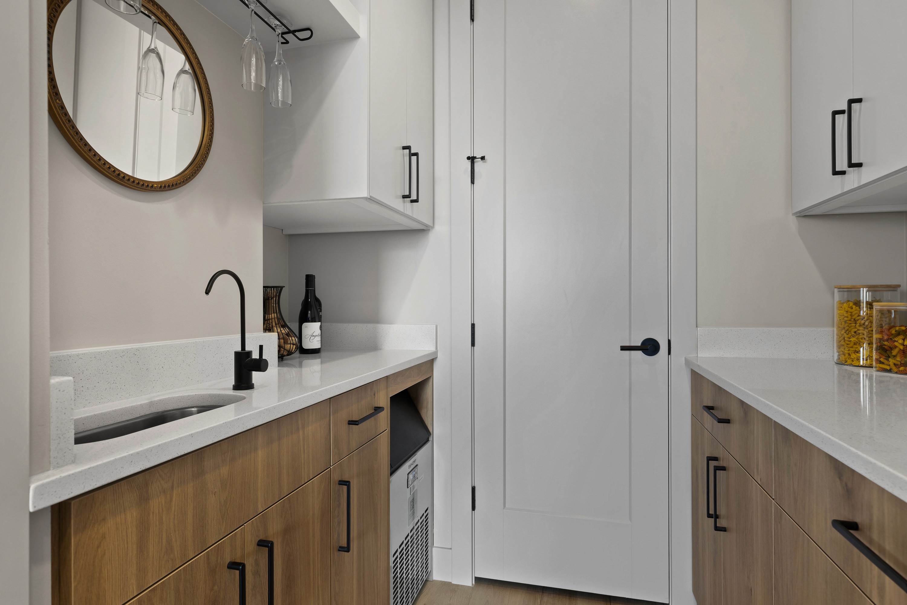 Drink station or butler’s pantry in the BYSO House in Hurricane, Utah with cabinetry and storage.