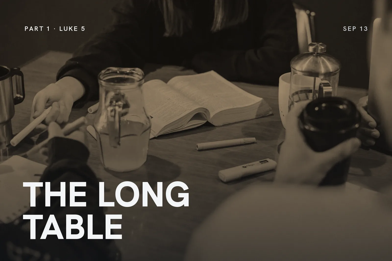 Series artwork for The Long Table: an open Bible and water glasses on a shared table