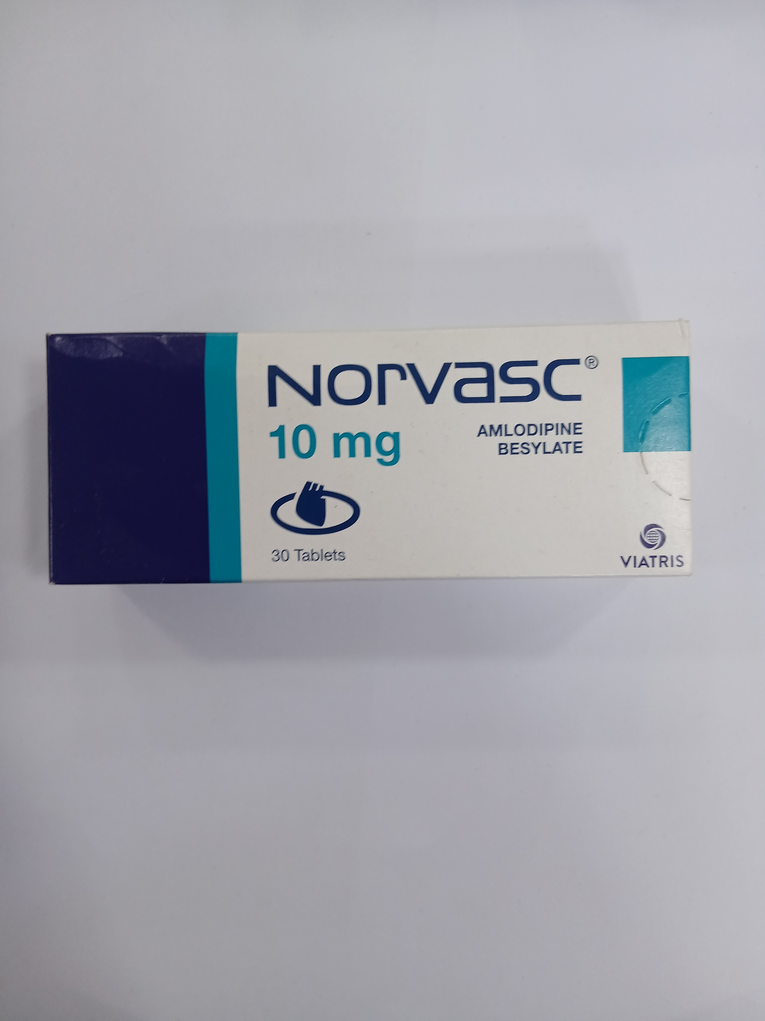 White cardboard packaging with a blue and light blue label displays text indicating a medication strength of 10 mg containing 30 tablets.