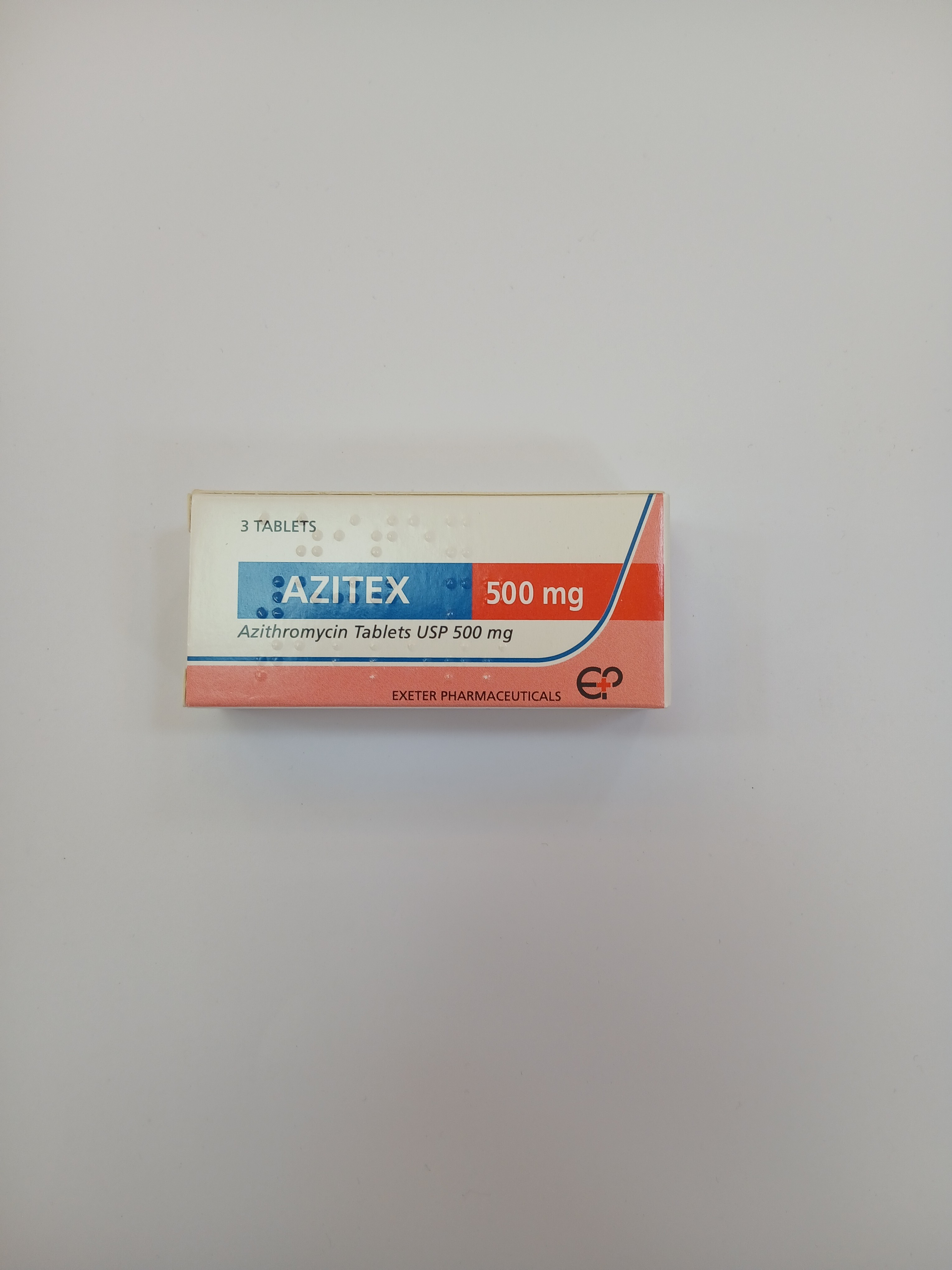 A small, rectangular white cardboard box with blue and red accents, labeled "AZITEX 500 mg" and "Azithromycin Tablets USP 500 mg", is centered on a plain white background.