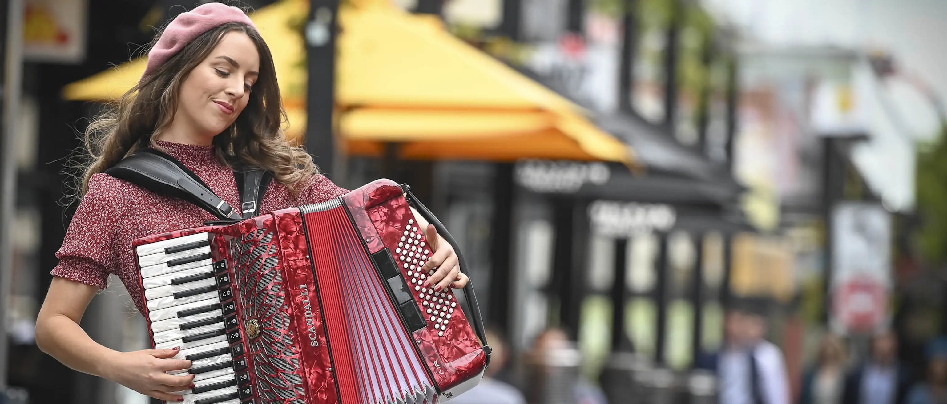 Lucy performing at an event on her red accordion