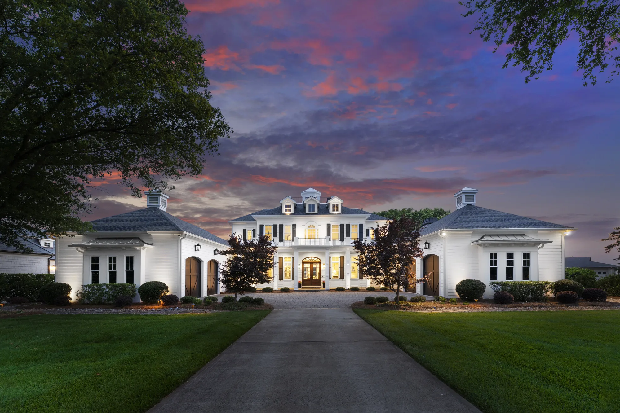 Colonial lake home at twilight