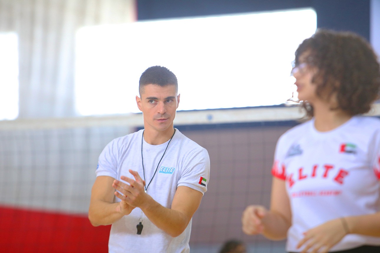 Coach giving tips to a student during Volleyball practice