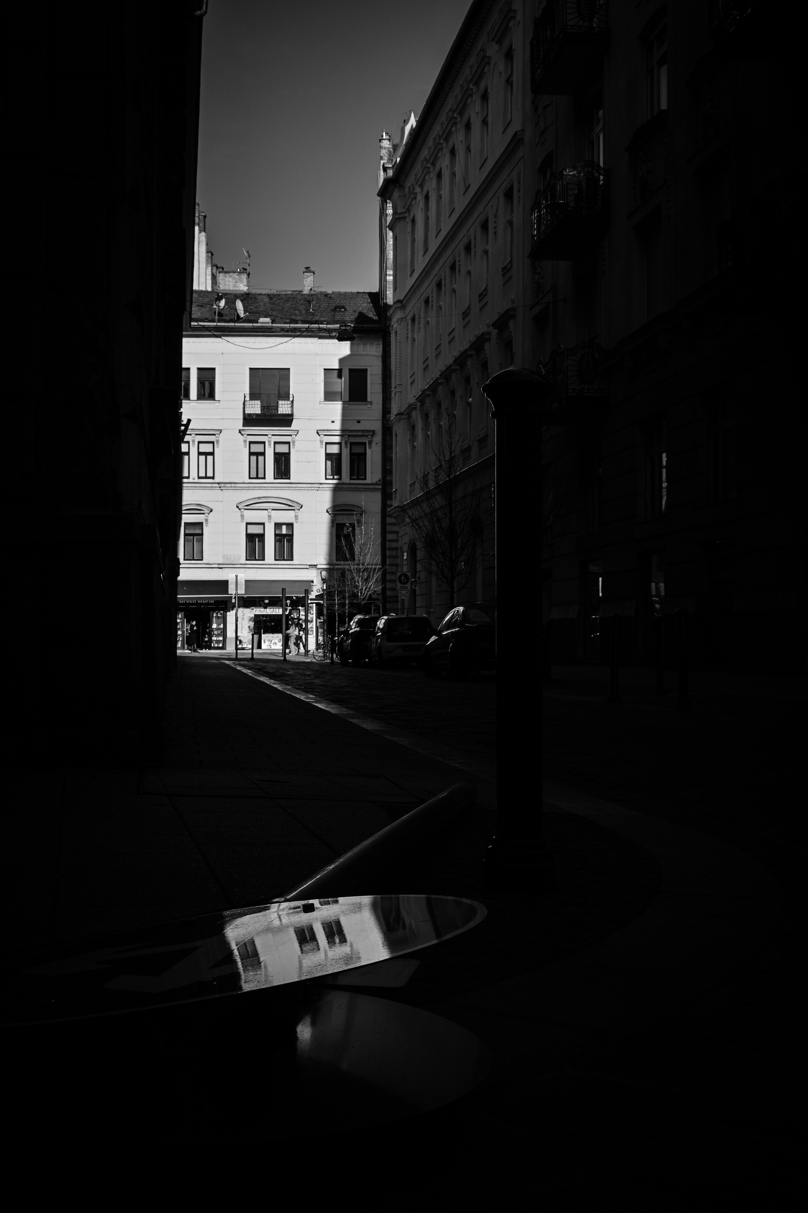Black and white street scene with reflection.