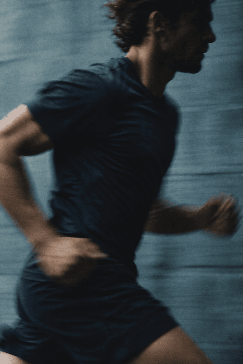 A male runner in motion, seen in shadow