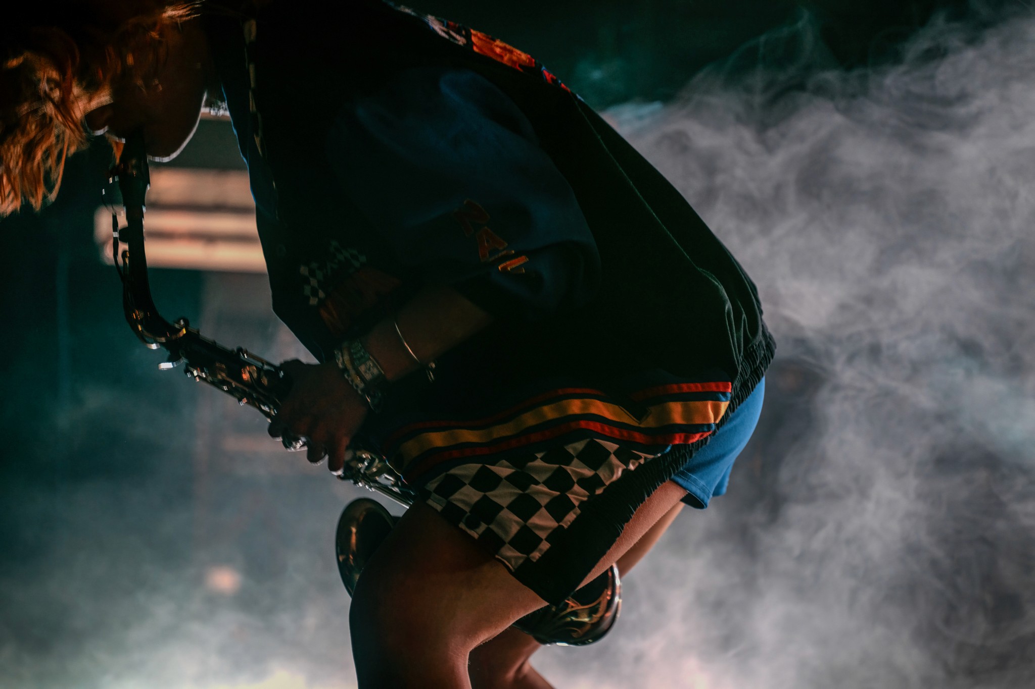 Female playing sax in the middle of fog
