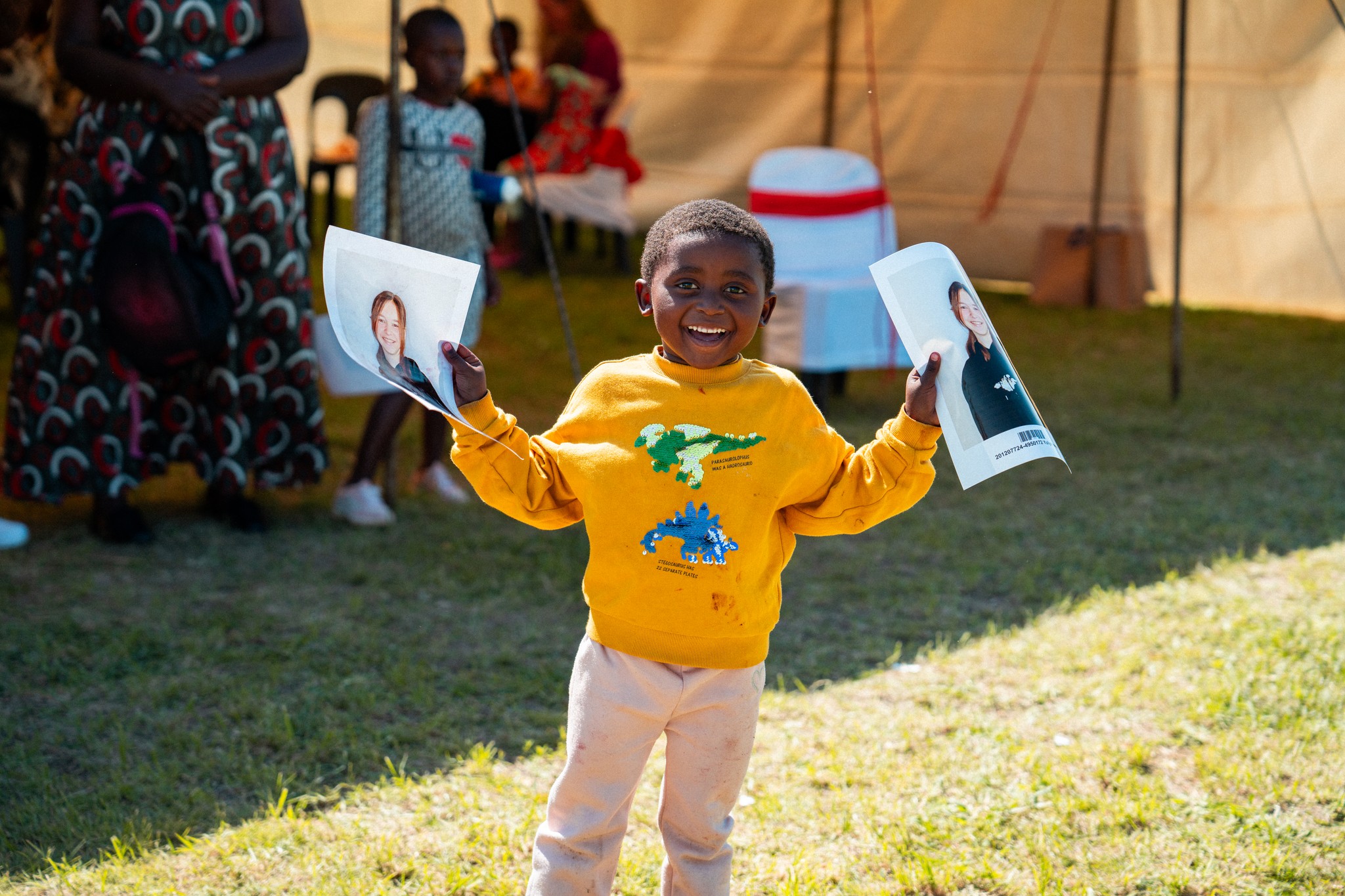 person sitting on grass and using phone
