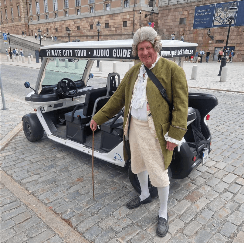 Tourists exploring Stockholm during private electric sightseeing cart tour