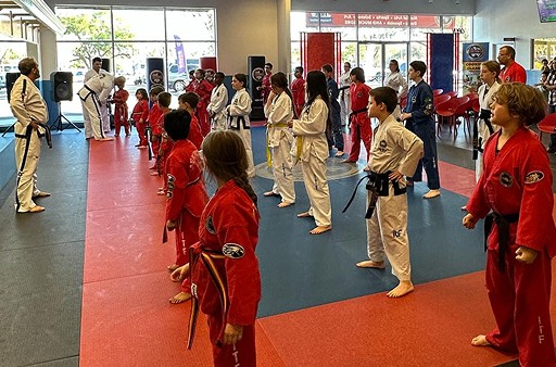 Group of attendees looking at the instructor of a Taekwondo class.