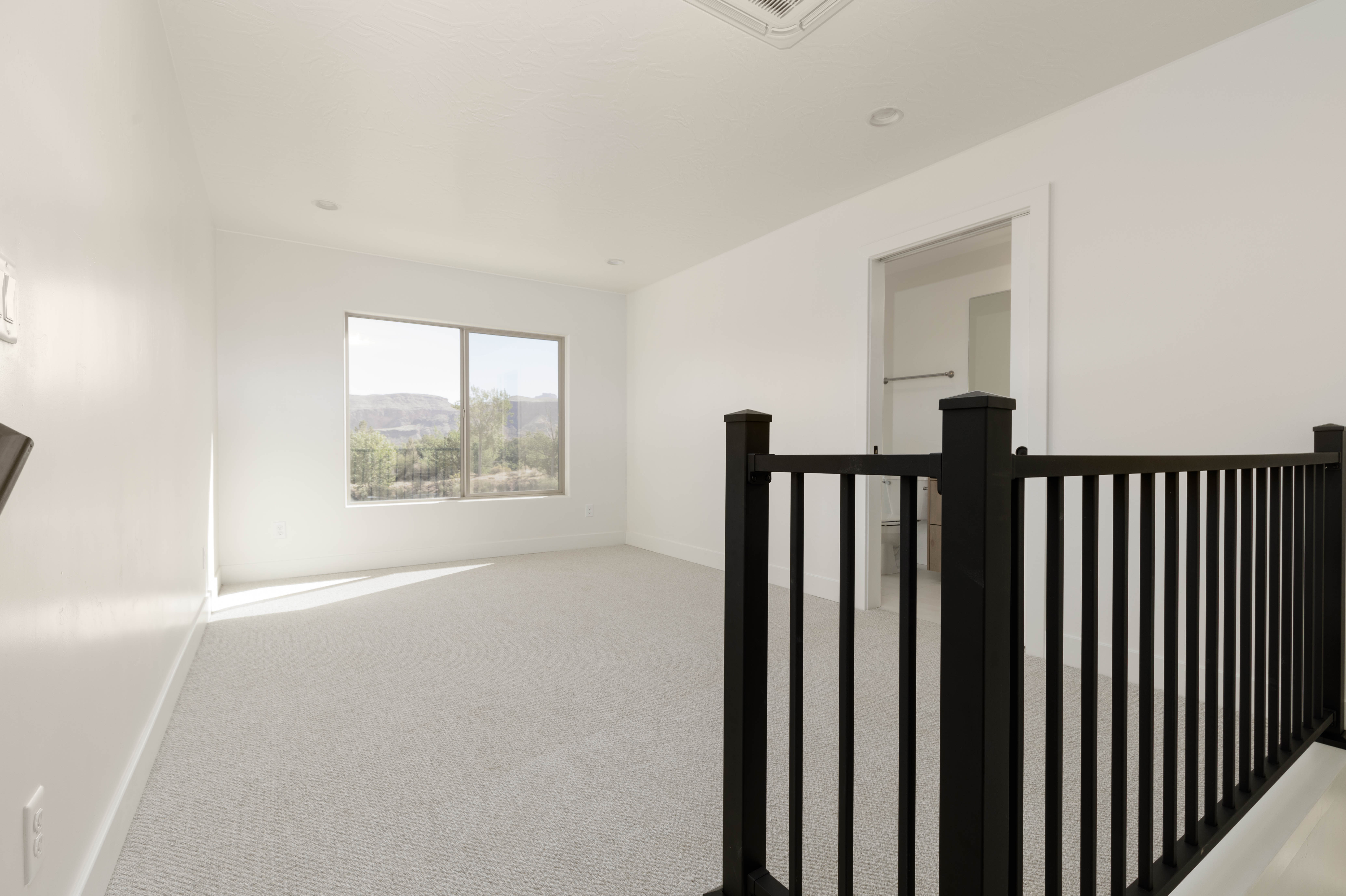 Comfortable guest bedroom in attached casita suite in Hurricane Utah new construction home.