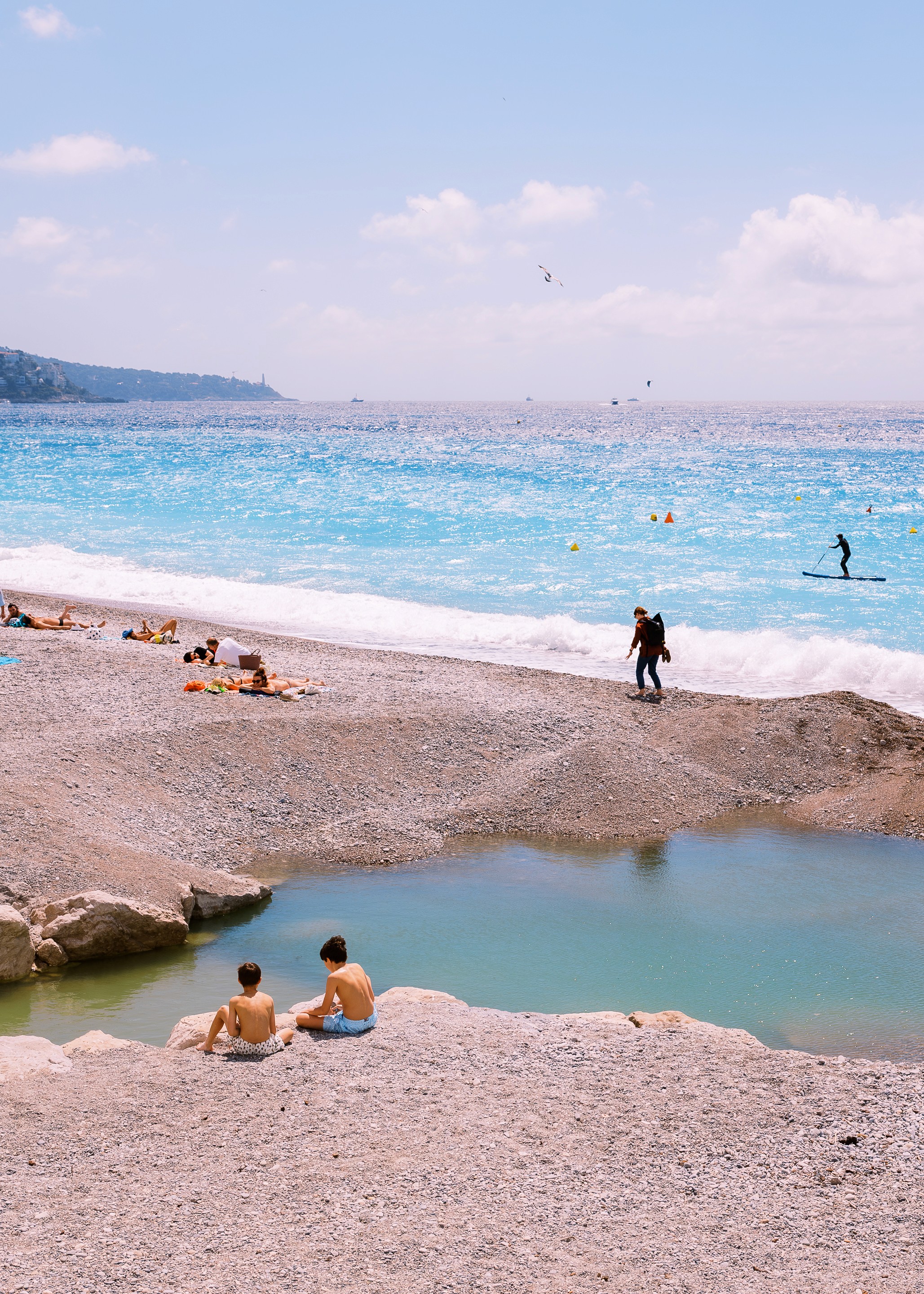 Two people talking on a rooftop at sunset