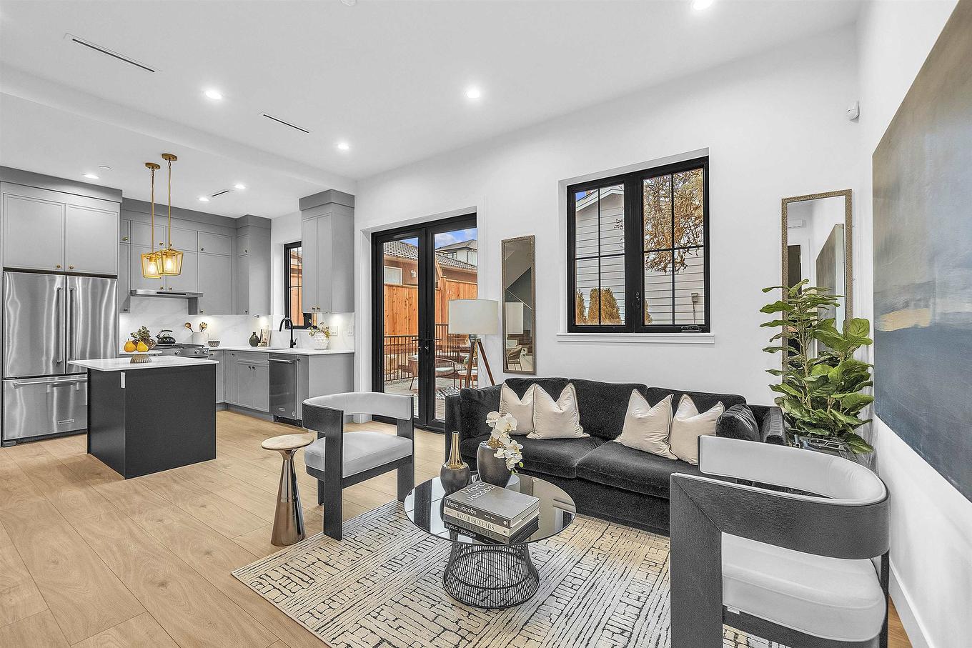 Modern living room with a cozy sofa, decorative pieces, and natural light from large windows.