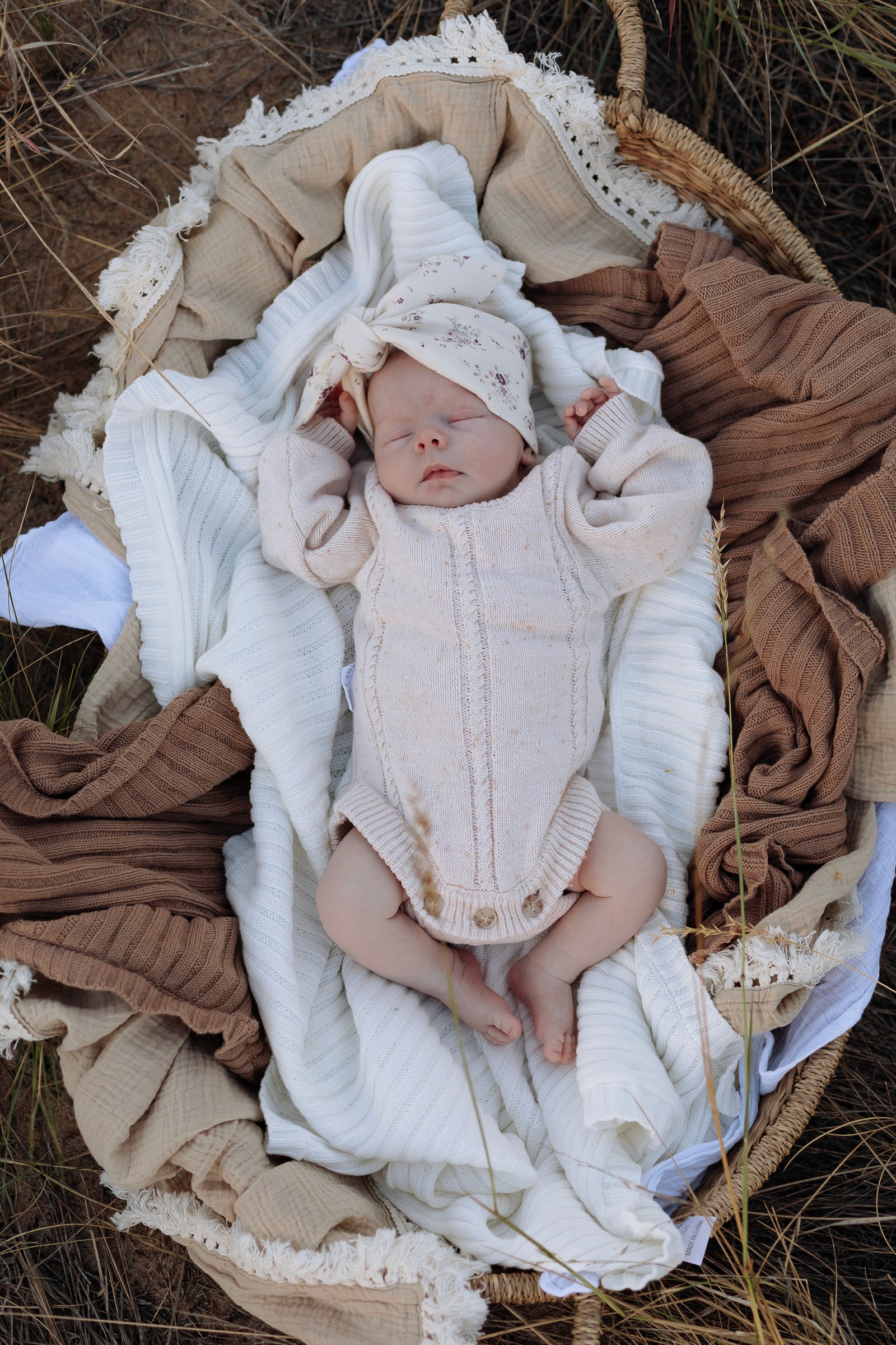 Newborn portrait of baby wrapped in soft natural light