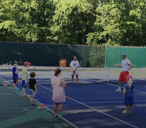 Outdoor adult tennis clinic group lesson serving Falls Church and the wider DMV area
